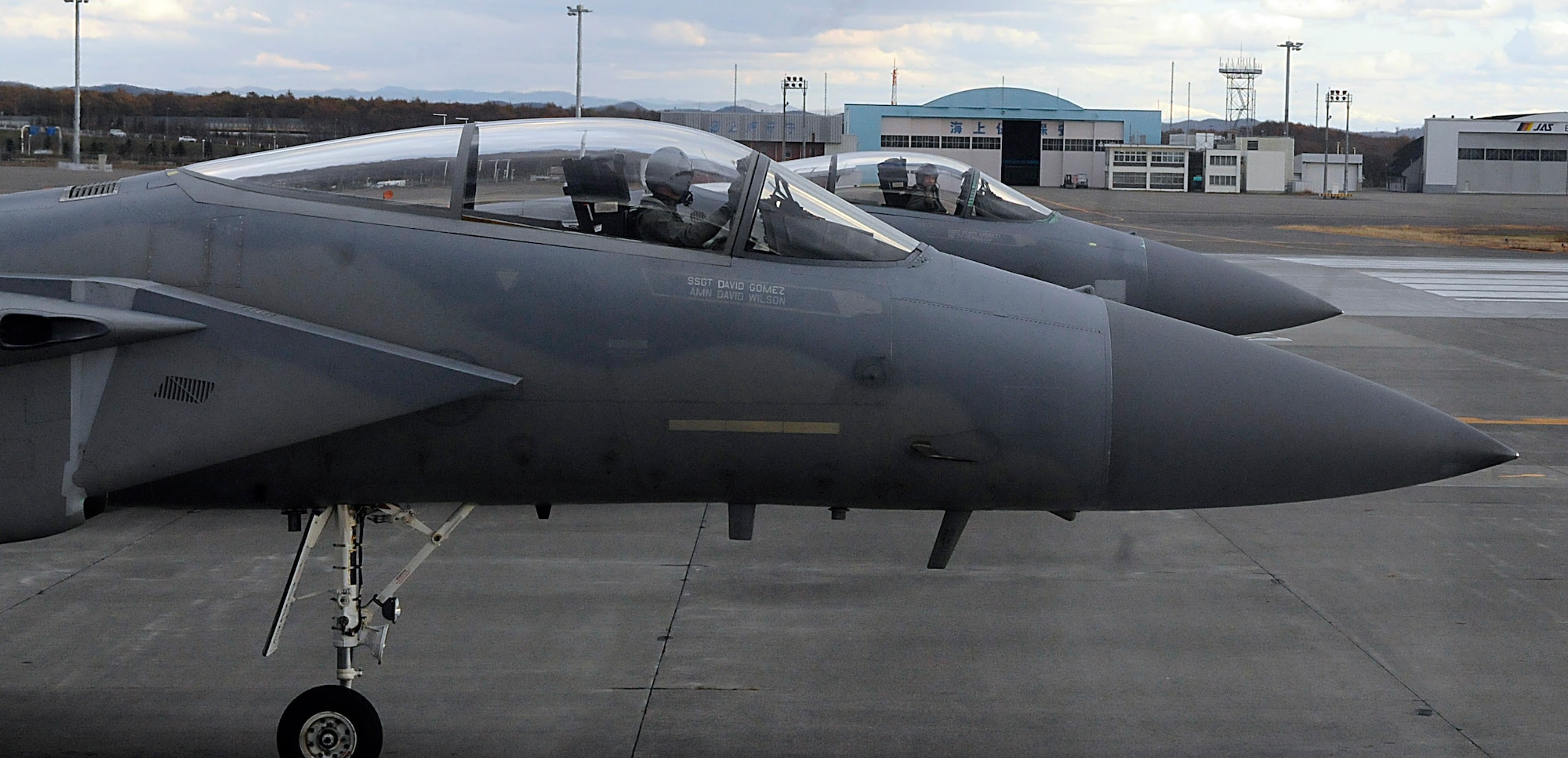 Capt. Tim Wegner and 1st Lt. Aaron Stevens wait on the end of runway for weapons crews to complete their final checks on an F-15 Eagle Nov. 17, 2001, at Chitose Air Base, Japan. The jets "trained against" Japan Air Self Defense Force pilots out of Misawa AB, Japan.  Captain Wegner and Lieutenant Stevens are from with the 44th Fighter Squadron. (U.S. Air Force photo/Tech. Sgt. Mike Tateishi) 