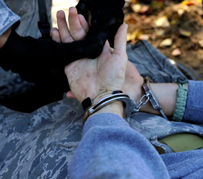 MOODY AIR FORCE BASE, Ga. -- A member of a 23rd Security Forces Squadron patrol secures and restrains an enemy while checking for any weapons or objects Nov. 17. The patrol team had to restrain, search and clear the subject, which is part of what they will be graded on during the upcoming Phase II Operational Readiness Inspection. (U.S. Air Force photo/Airman 1st Class Nicholas Benroth)(RELEASED)