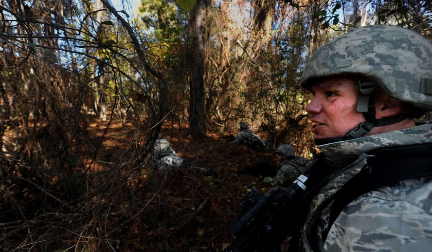 MOODY AIR FORCE BASE, Ga. -- Tech. Sgt. Clinton Ellis, 23rd Security Forces Squadron, NCO in charge of training, shouts to one of his squad leaders to move forward during a Phase II Operational Readiness Exercise Nov. 17. In the altercation between the 23rd SFS and the opposing forces, one team laid down suppressive fire while the other members conducted a sweep maneuver to apprehend the oppositional forces. (U.S. Air Force photo/Airman 1st Class Joshua Green)(RELEASED)
