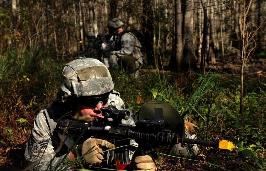 MOODY AIR FORCE BASE, Ga. -- Senior Airman John Little, 23rd Security Forces Squadron patrolman, takes position in the grass to keep look out and scan for opposing forces during a Phase II Operational Readiness Exercise Nov. 17. The 23rd SFS members operated in three different groups while scanning and attempting to locate opposing forces. (U.S. Air Force photo/Airman 1st Class Joshua Green)(RELEASED)
