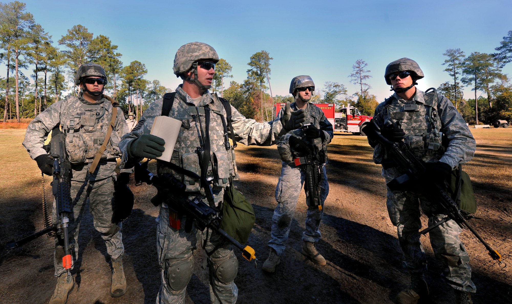 MOODY AIR FORCE BASE, Ga.-- Members from the 23rd Security Forces Squadron group together for an equipment check and discuss their plan of operation during a Phase II Operational Readiness Exercise Nov. 17. The scenario for the 23rd SFS members was to patrol an area where suspicious activity was reported and engage the opposing forces. (U.S. Air Force photo/Airman 1st Class Joshua Green)(RELEASED)
