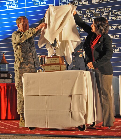 Lt. Gen. Frank Klotz, commander of Air Force Global Strike Command, and Mrs. Angelle Tibbets, granddaughter-in-law of then-Col. Paul W. Tibbets Jr., first commander of the 509th Composite Group, unveil the Tibbets Trophy for Best B-2 Operations Squadron at the score posting Nov. 16 at Barksdale Air Force Base, La. The 13th Bomb Squadron from Whiteman Air Force Base, M.O. was awarded this trophy. (U.S. Air Force photo/Senior Airman Alexandra M. Boutte)
