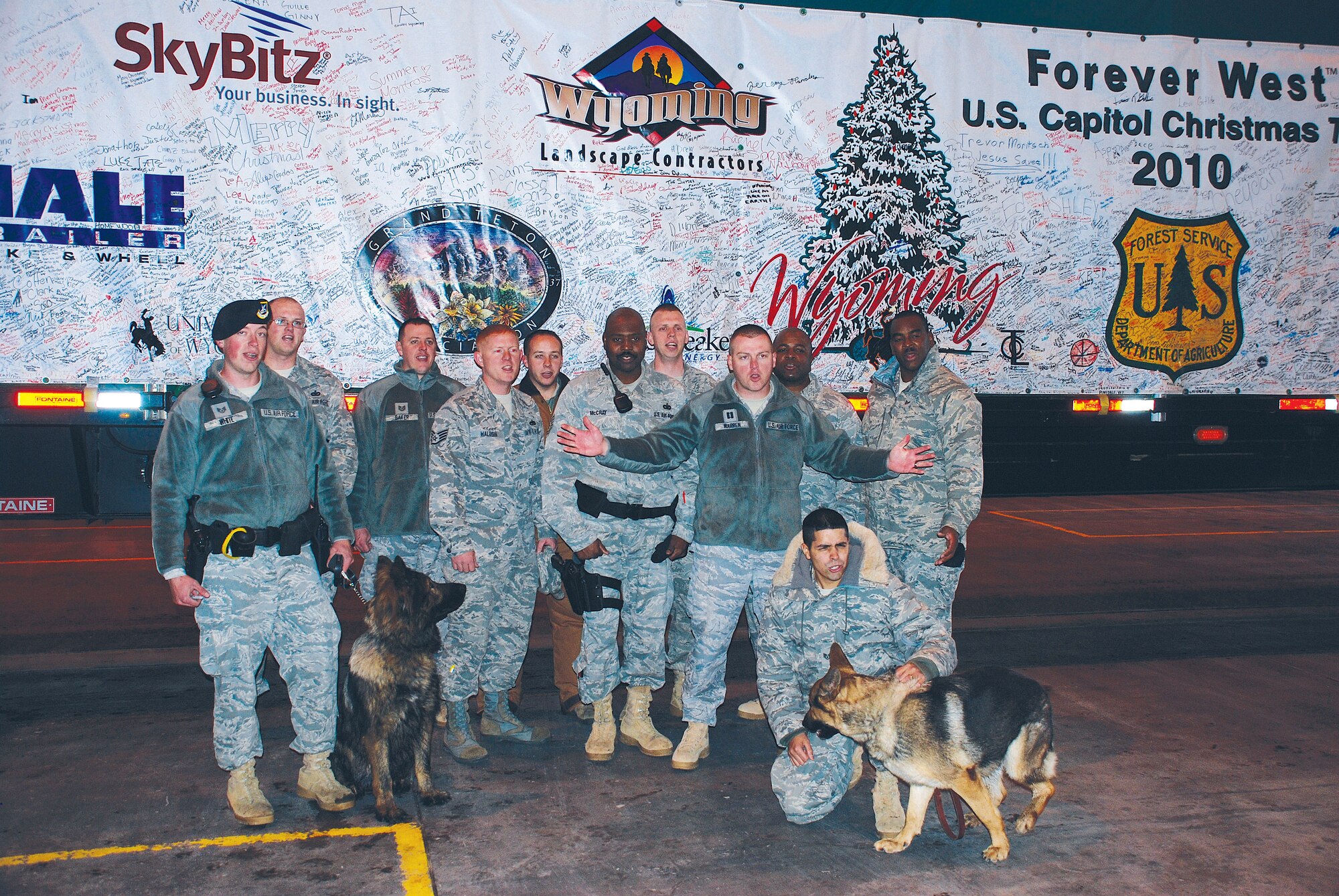 Members of F. E. Warren Air Force Base while standing in front of the truck containing the 2010 Congressional Christmas tree wish everyone a Merry Christmas on behalf of the Air Force and the Mighty Ninety. (U.S. Air Force photo by Col. Scott Fox)