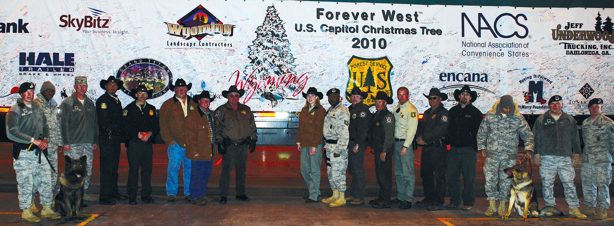 Col. Scott Fox, 90th Missile Wing vice commander, security forces members and United States Forest Service members pose for a photo  alongside the trailer containing the 2010 Congressional Christmas tree Wednesday. The tree was selected out of the Bridger-Teton National Forest, Wyo. (U.S. Air Force photo by Staff Sgt. Mike Tryon)