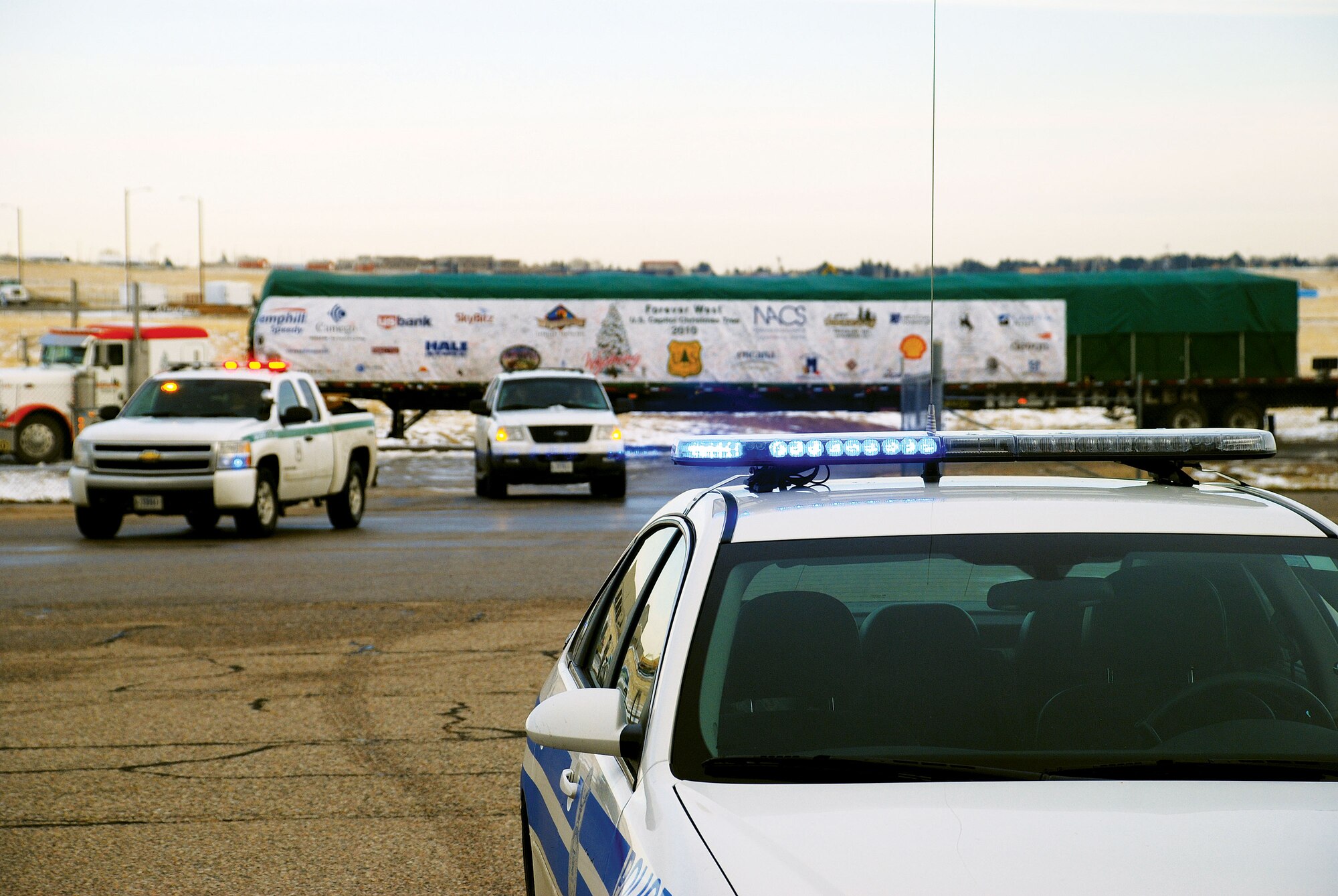 Security forces and United States Department of Agriculture Forest Services members provide escort for the 2010 Congressional Christmas tree as it makes its way to its overnight destination of F. E. Warren on Wednesday. (U.S. Air Force photo by Staff Sgt. Mike Tryon)
