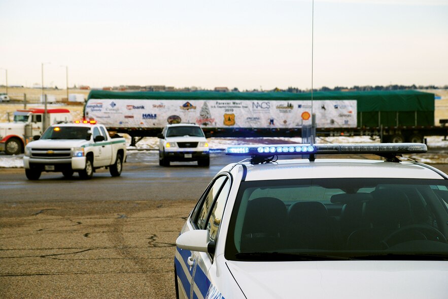 Security forces and United States Department of Agriculture Forest Services members provide escort for the 2010 Congressional Christmas tree as it makes its way to its overnight destination of F. E. Warren on Wednesday. (U.S. Air Force photo by Staff Sgt. Mike Tryon)