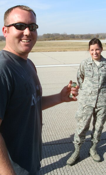 WRIGHT-PATTERSON AIR FORCE BASE, Ohio - Tech. Sgt. Spencer Fisher, 445th Aircraft Maintenance Squadron, found the “Golden Bolt” during the Nov. 10 base-wide FOD walk.  Sergeant Fisher was awarded a gift certificate to a local merchant for finding the hidden foreign object. Forty members from the 445th Airlift Wing joined 150 men and women from across the base in the FOD walk, finding more than 440 pounds of debris on the base’s main 12,000 foot runway. (U.S. Air Force photo/Capt. Rodney McNany)