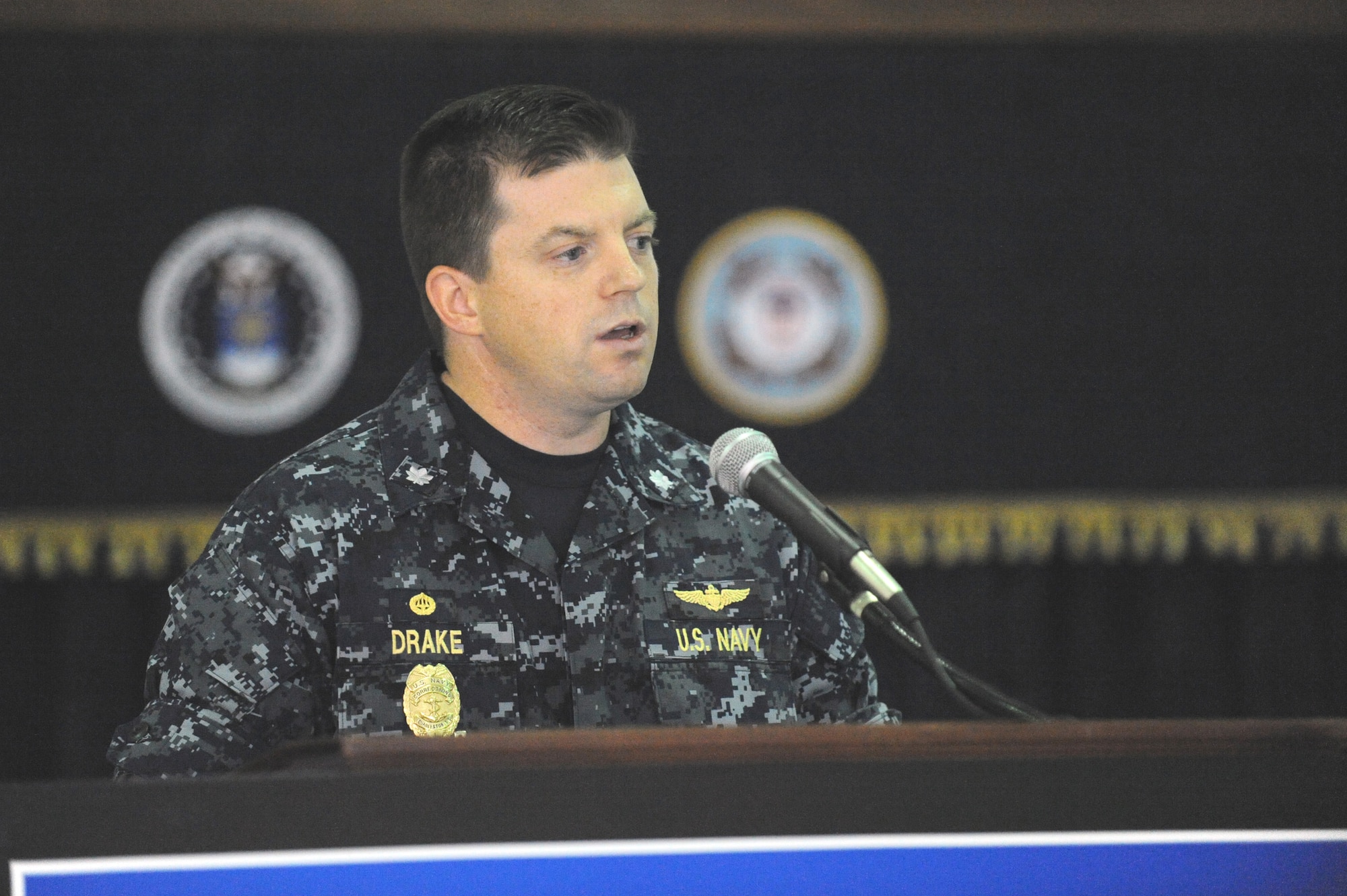 Navy Cmdr. Raymond Drake gives his opening remarks about the Service Dog Program while at the Naval Consolidated Brig Charleston Nov. 18, 2010, on Joint Base Charleston-Weapons Station. The Service Dog Program, which works in partnership with Carolina Canines for Service, placed its first prisoner trained service dog with a wounded veteran. The Carolina Canines for Service is a non-profit health and human services organization that trains service dogs for people with disabilities. Commander Drake is the commanding officer for Naval Consolidated Brig Charleston. (U.S. Air Force photo/James M. Bowman)