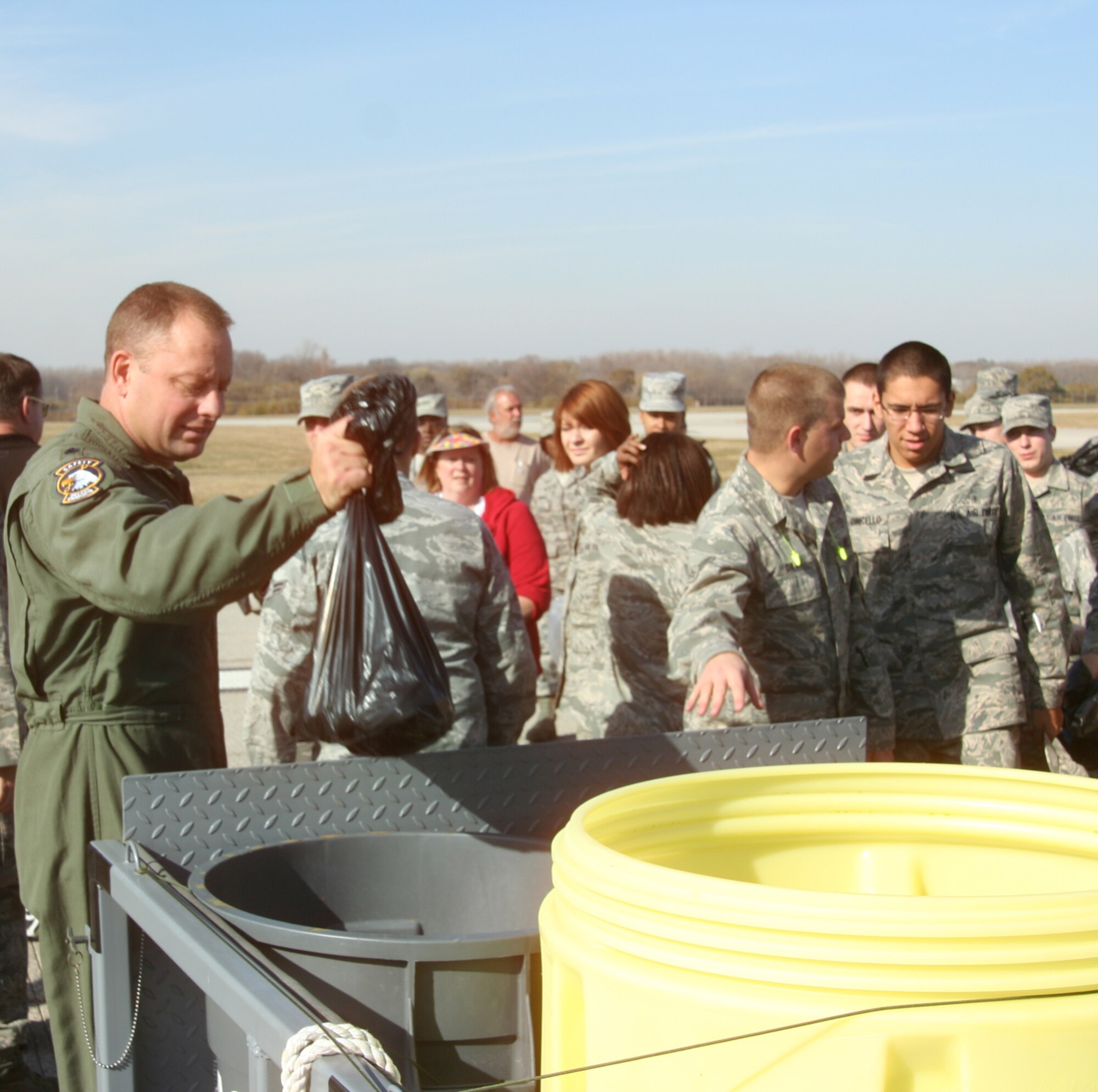WRIGHT-PATTERSON AIR FORCE BASE, Ohio - Lt. Col. Bill Barton, 445th Airlift Wing safety office, deposits a bag of collected foreign objects picked up during the Wright-Patterson Air Force Base FOD walk Nov. 10. Forty members from the 445th Airlift Wing joined 150 men and women from across the base to participate in the FOD walk, finding more than 440 pounds of debris on the base’s main 12,000 foot runway. (U.S. Air Force photo/Capt. Rodney McNany)