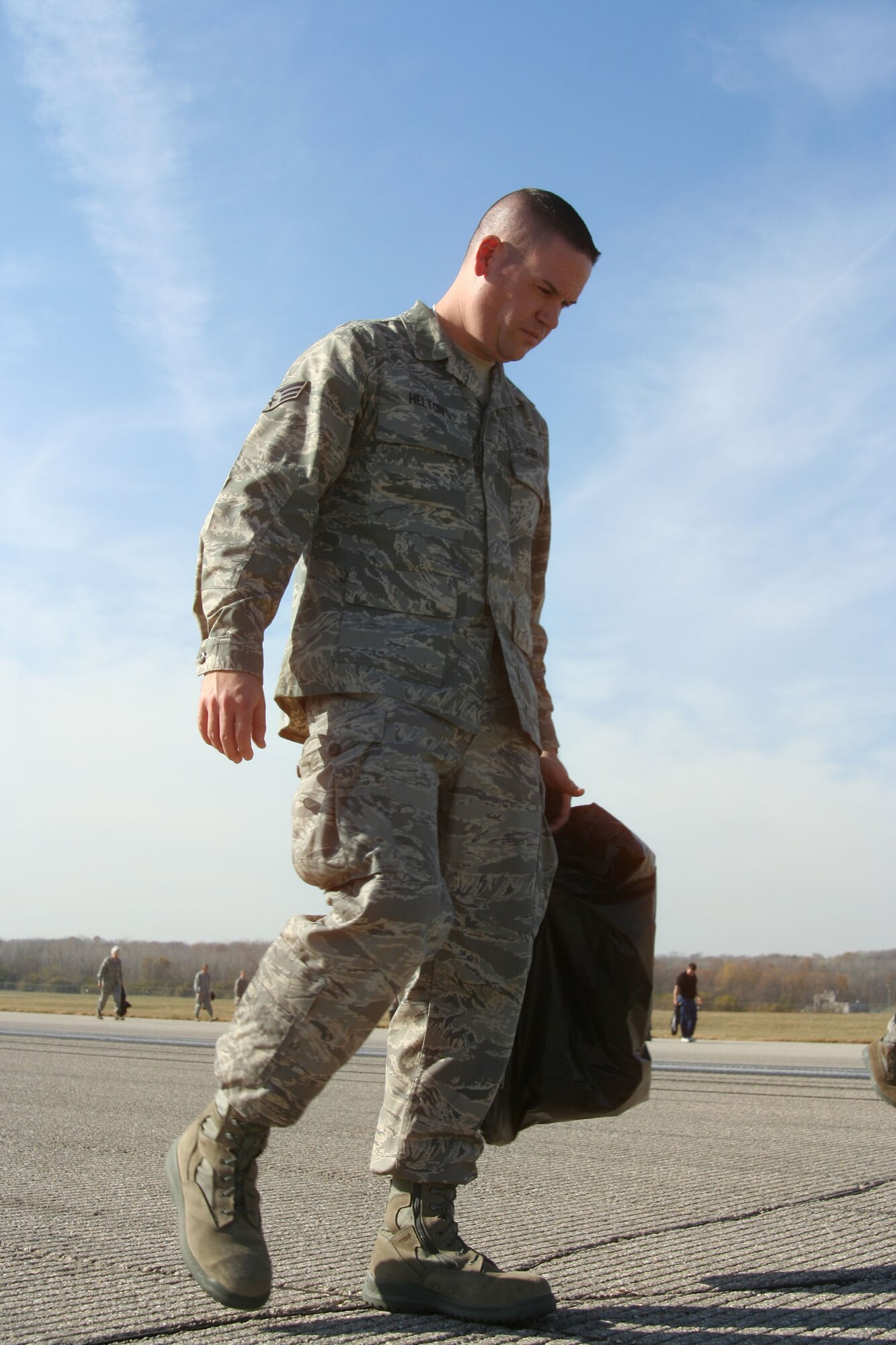 WRIGHT-PATTERSON AIR FORCE BASE, Ohio - Senior Airman David Helton, Jr., 445th Logistics Readiness Squadron, participated in a base-wide FOD walk Nov. 10 with 40 members from the 445th Airlift Wing and 150 men and women from across the base.  FOD walkers conducted a detailed inspection and found more than 440 pounds of debris on the base’s main 12,000 foot runway. (U.S. Air Force photo/Capt. Rodney McNany)