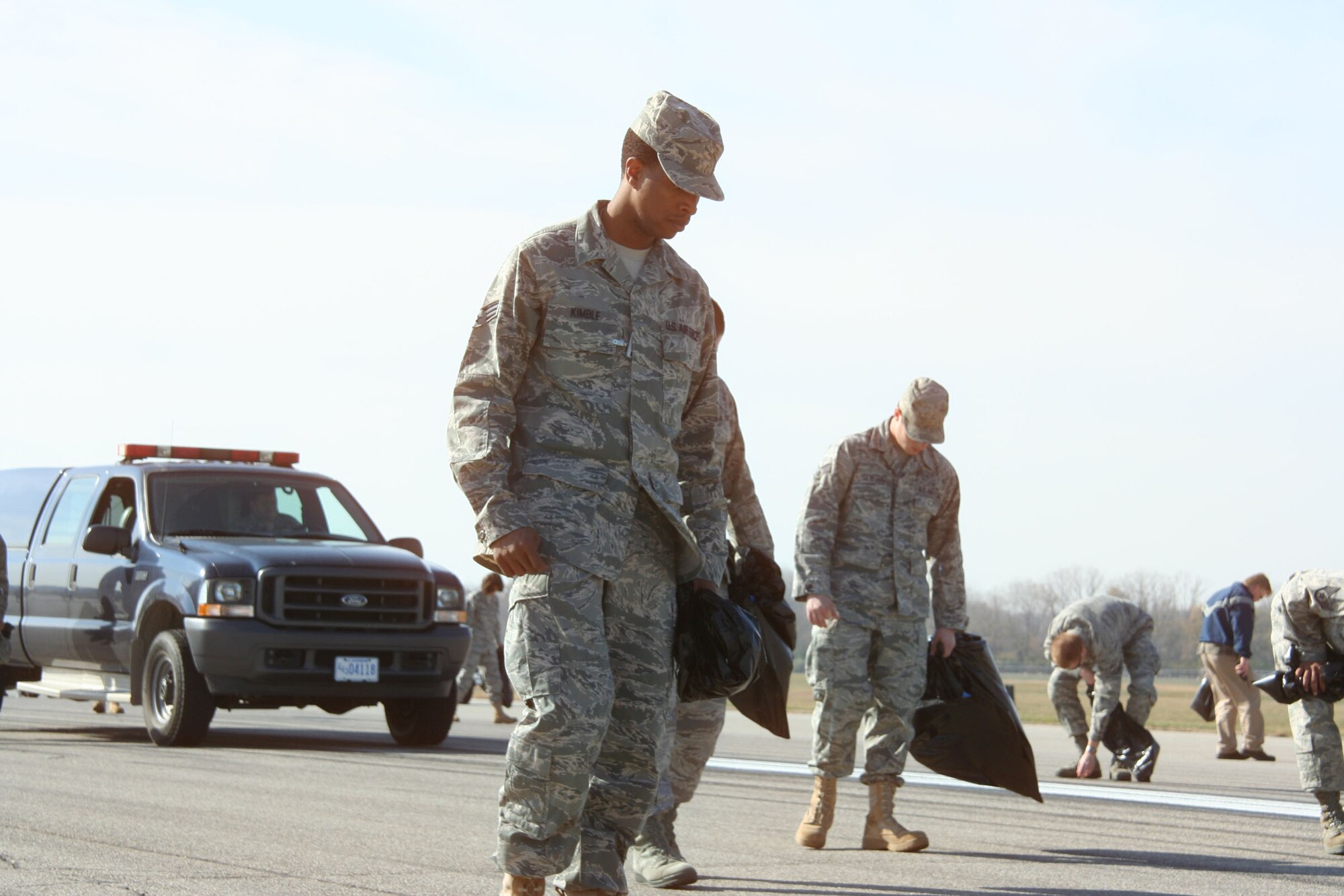 WRIGHT-PATTERSON AIR FORCE BASE, Ohio - Senior Airman Dennis Kimble, 445th Logistics Readiness Squadron, took part in a base-wide FOD walk Nov. 10 with 40 members from the 445th Airlift Wing and 150 men and women from across the base.  FOD walkers conducted a detailed inspection and found more than 440 pounds of debris on the base’s main 12,000 foot runway. (U.S. Air Force photo/Capt. Rodney McNany)