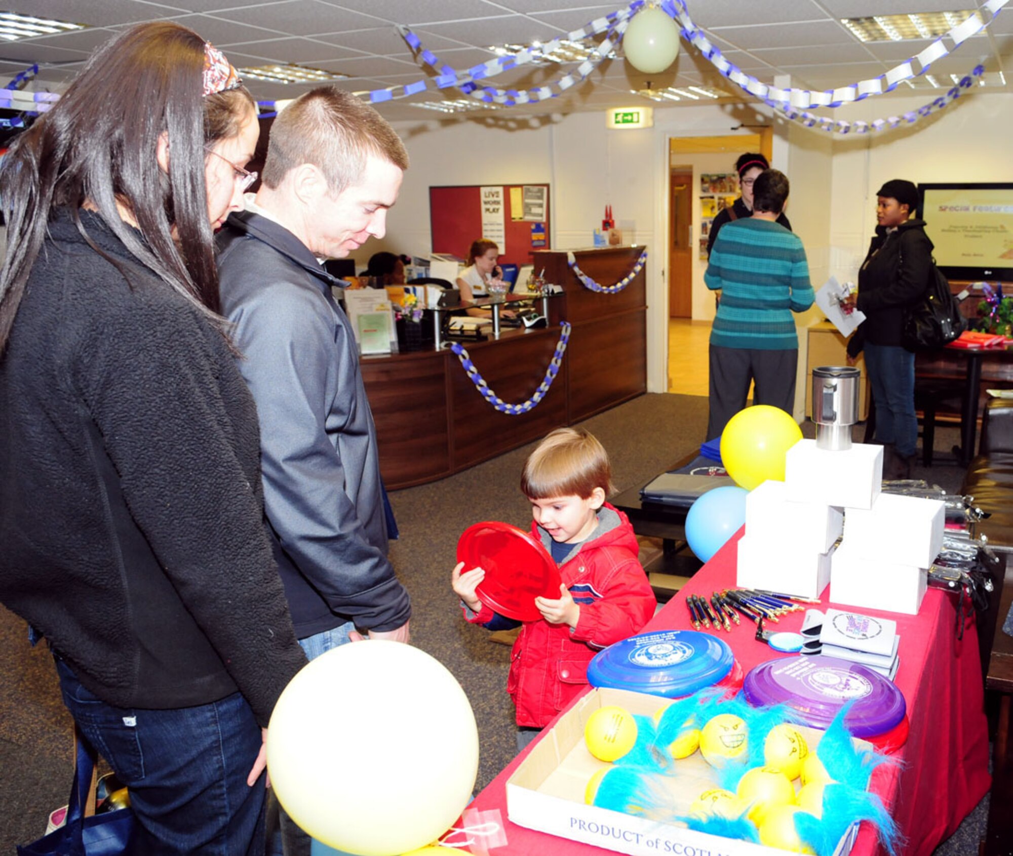 RAF MILDENHALL, England -- Jeremy Furse, 3, excitedly checks out his frisbee at the Airman and Family Readiness Center open house Nov. 18, 2010. As part of Month of the Military Family, the A&FRC held the event, which included giveaways, to introduce RAF Mildenhall members and their families to resources available to them. (U.S. Air Force photo/Karen Abeyasekere)