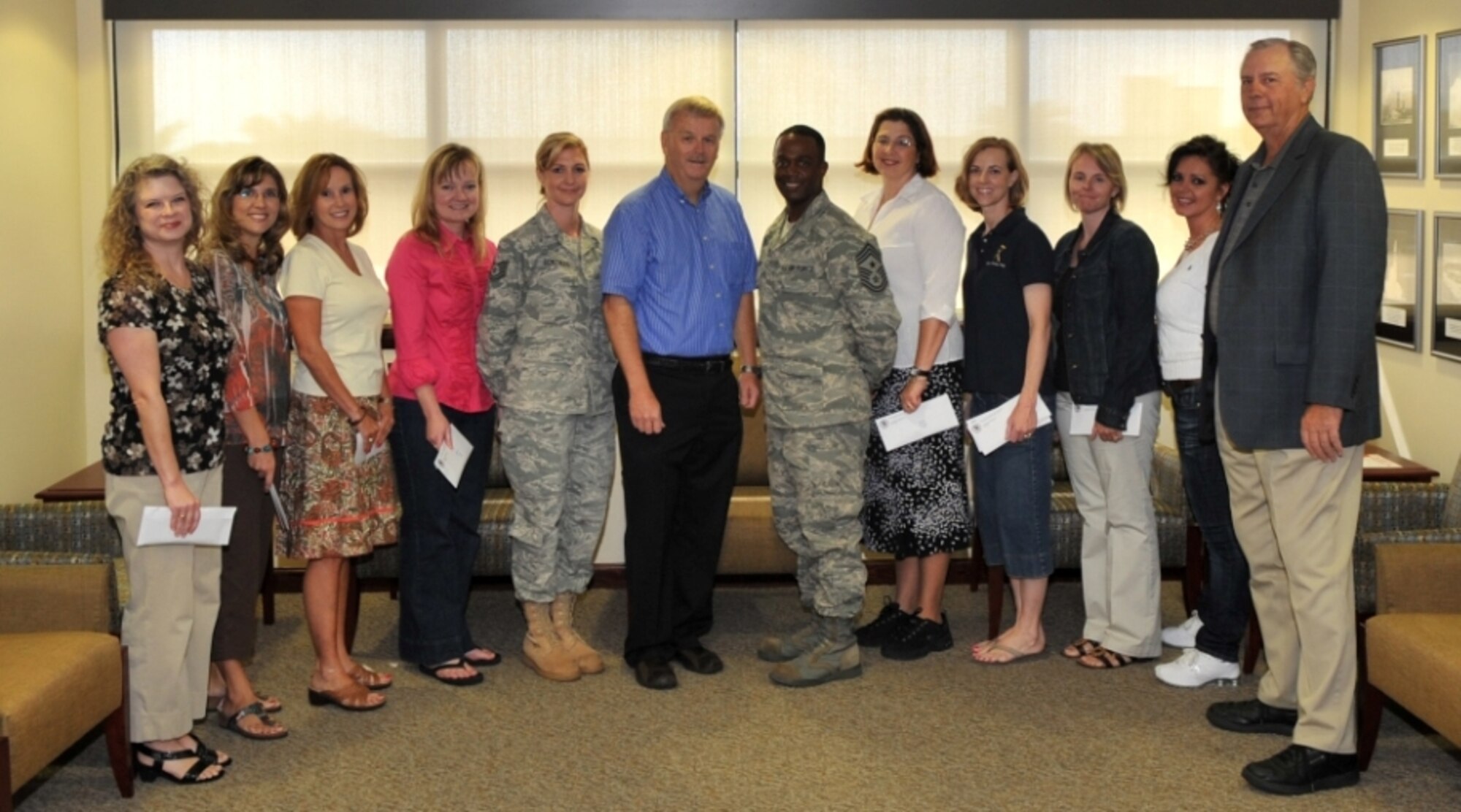 Mr. David Spain (center) and Mr. Don Beck (far right), both members of the Brevard County Civilian/Military Council, honor the men and women of Patrick Air Force Base Nov. 12 by presenting the 45th Space Wing Command Chief, Chief Master Sgt. Calvin Williams, Sr., and members of the Key Spouses Group gift cards valued at more than $14,000 to be used by deployed Airmen and their families. Civ/Mil constantly is working to support our Airmen and our mission partners and this is just one shining example of the tremendous support we receive from our Space Coast Community.