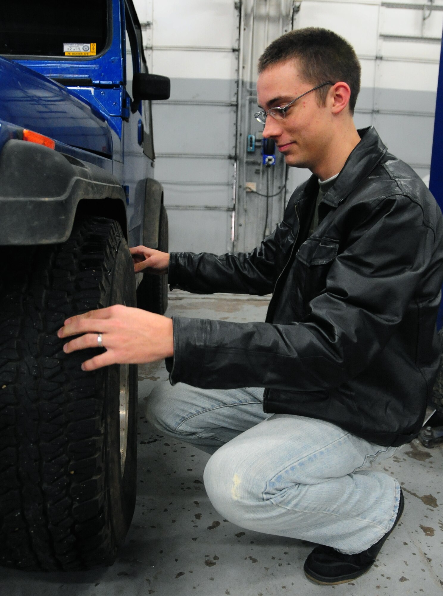 ELLSWORTH AIR FORCE BASE, S.D. - Airman 1st Class Eli Goff, 28th Operations Group air traffic controller, checks the tread on his tires for safety during the winter season, Nov. 17.  All Airmen should check vehicles throughout the winter and before long trips to ensure the vehicle won't break down. (U.S. Air Force photo/Senior Airman Anthony Sanchelli)

