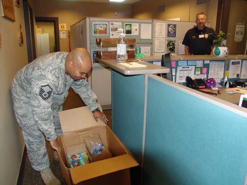 Air Force Master Sgt. Andre McDowell unloads a box of items on Nov. 15, 2010, to be added to care packages for AEDC personnel deployed overseas in Africa and Afghanistan. Four Air Force members from the base currently are deployed. (Photo by Patrick Ary)