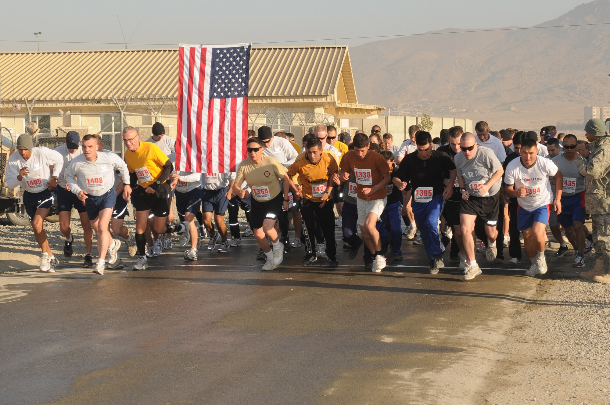 KABUL, Afghanistan -- Runners take off following the start of the 5th Annual LT Dennis W. Zilinski II Memorial 5K Run/Walk Nov.  19 at Kabul International Airport. The race is in honor of 1st Lt. Dennis Zilinski who died supporting combat opertaions in Iraq on Nov. 2005. (US Navy photo by MC3 Jared Walker)