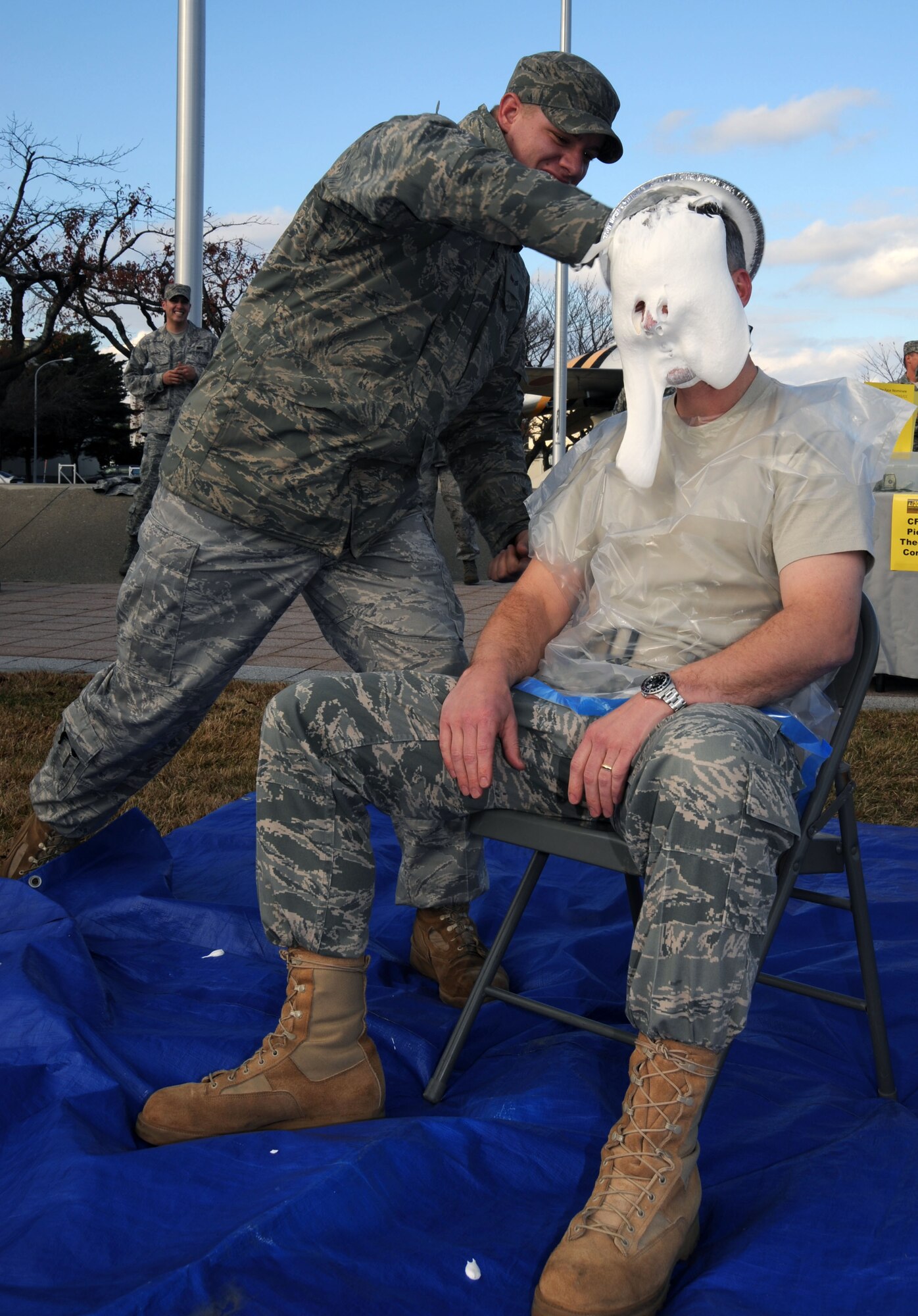 U.S. Air Force Senior Airman Andrew Hunewill, left, 35th Logistics Readiness Squadron, places a pie in the face of Col. David Wiegand, right, 35th Mission Support Group commander, during Combined Federal Campaign fundraiser at Misawa Air Base, Japan, Nov. 18, 2010. Colonel Wiegand raised donations in $50.95 in support of CFC. Members of Misawa community can help contribute by contacting thier unit representatives.(U.S. Air Force photo by Tech. Sgt. Russell McBride/Released) 