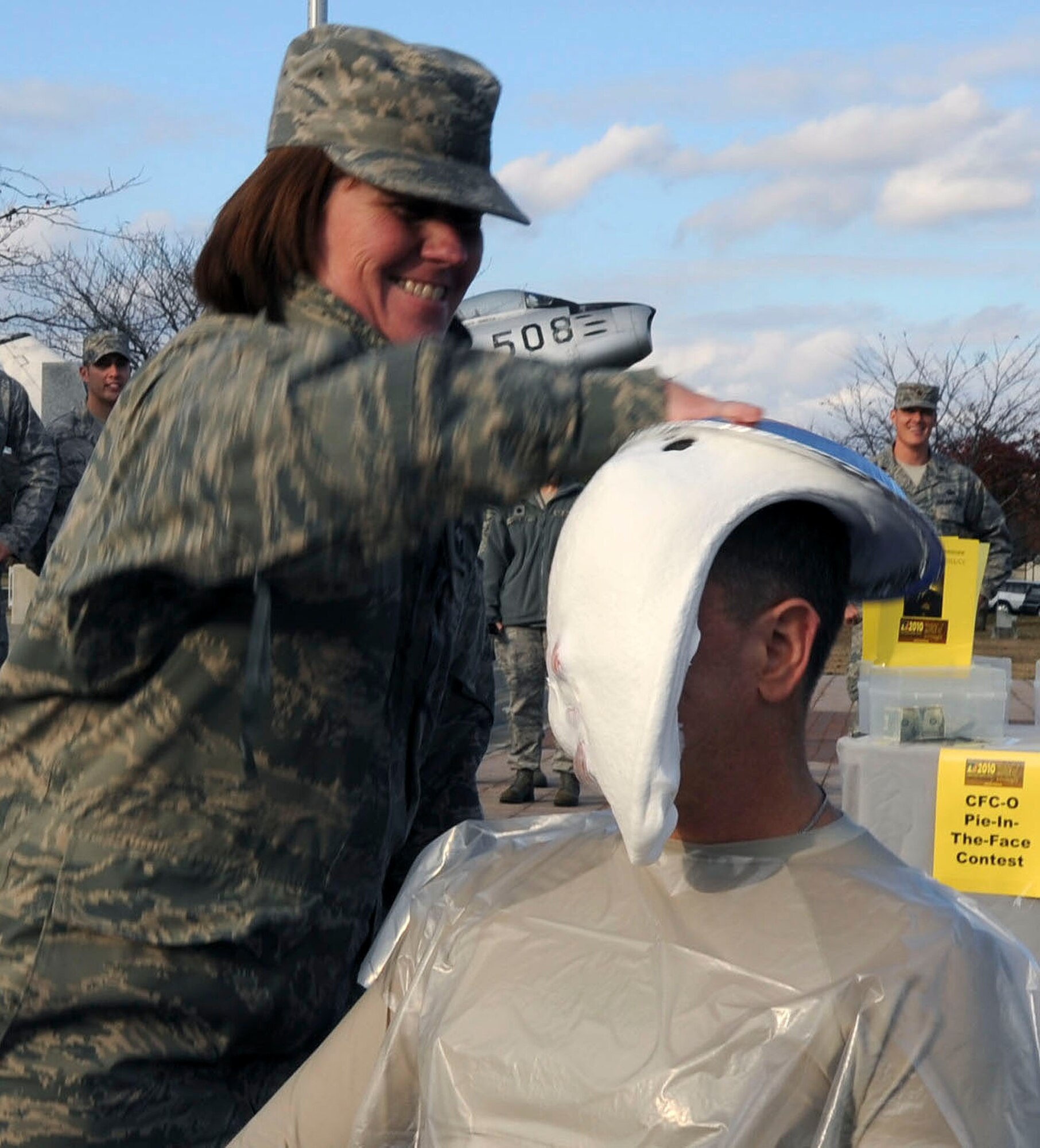 U.S. Air Force Chief Master Sgt. Joann Link, left, 35th Medical Group, smears a pie in the face of Chief Master Sgt. Russ Hastings, right, 35th Fighter Wing command chief, during a Combined Federal Campaign fundraiser at Misawa Air Base, Japan, Nov. 18, 2010. Chief Hastings raised donations in $58.43 in support of this year's event. The CFC runs Oct. 4 through Dec. 3. (U.S. Air Force photo by Tech. Sgt. Russell McBride/Released) 