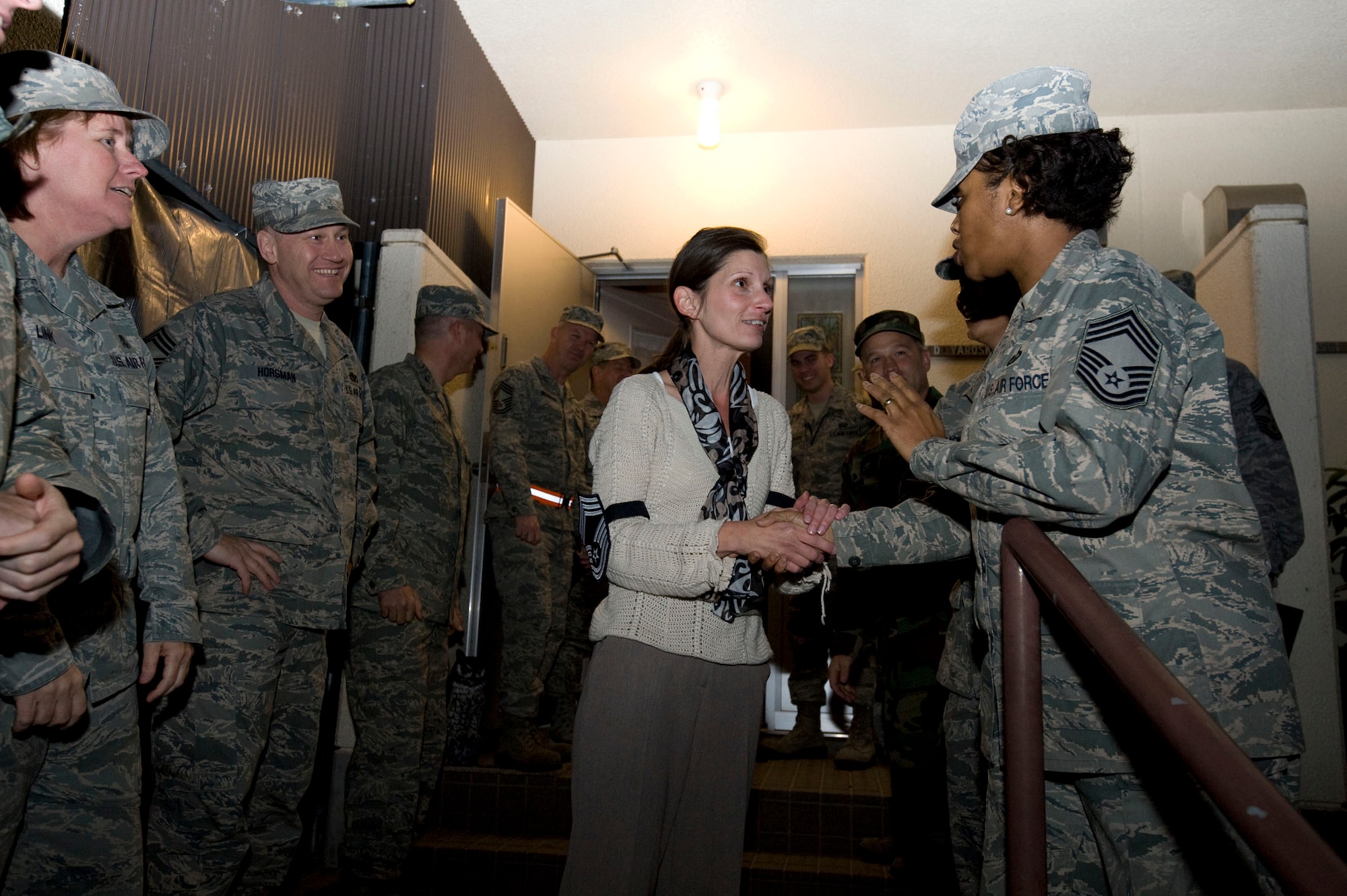 U.S. Air Force Chief Master Sgt. Arlene Murray, right, Misawa Security Operations Center, congratulates Mrs. Varoskovic at Misawa Air Base, Japan, Nov 18, 2010. Varoskovic's husband, Senior Master Sergeant David Varoskovic, 35th Maintenance Squadron, was selected for promotion to the rank of Chief Master Sergeant. Due to his being deployed, Mrs. Varoskovic accepted the news on his behalf. Misawa leadership recognized the installation's newest Chief selects by delivering the news as a group. (U.S. Air Force photo by Airman James B. Bauer/Released) 