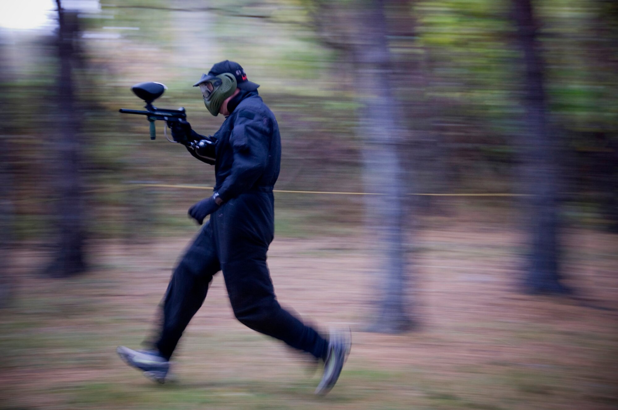 Tech. Sgt. Rory Stark, 35th Civil Engineer Squadron Explosive Ordnance Disposal technician, rushes through a paintball course, Nov. 10, 2010, during an annual EOD Safety Stand-down day at Misawa Air Base, Japan. The day offered the technicians an opportunity to take a strategic pause in their daily operations to reflect on aspects of their job as well as work on team building through stress alleviating activities.  (U.S. Air Force photo by Senior Airman Jessica Lockoski) 