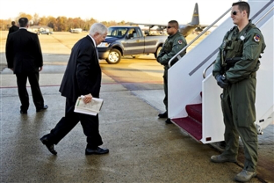 Defense Secretary Robert M. Gates arrives on Andrews Air Force Base, Md., and boards the National Airborne Operations Center aircraft en route to South America, Nov. 19, 2010. 