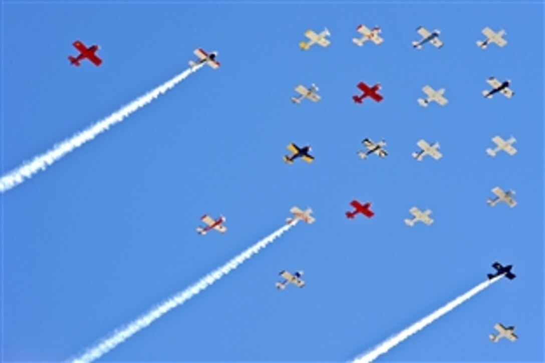 Trainer aircraft from various time periods create a colorful formation during an air show on Nellis Air Force Base, Nev., Nov. 13, 2010. The open house is an opportunity for the Las Vegas community to view aerial demonstrations and static displays of military aircraft.