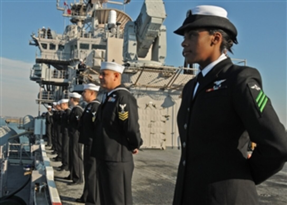 Sailors man the rails aboard the multi-purpose amphibious assault ship USS Iwo Jima (LHD 7) as they return to Norfolk after a four-month Continuing Promise 2010 humanitarian civic assistance mission on Nov. 18, 2010.  The assigned medical and engineering staff embarked aboard the Iwo Jima worked with partner nation teams to provide medical, dental, veterinary and engineering assistance in eight countries.  