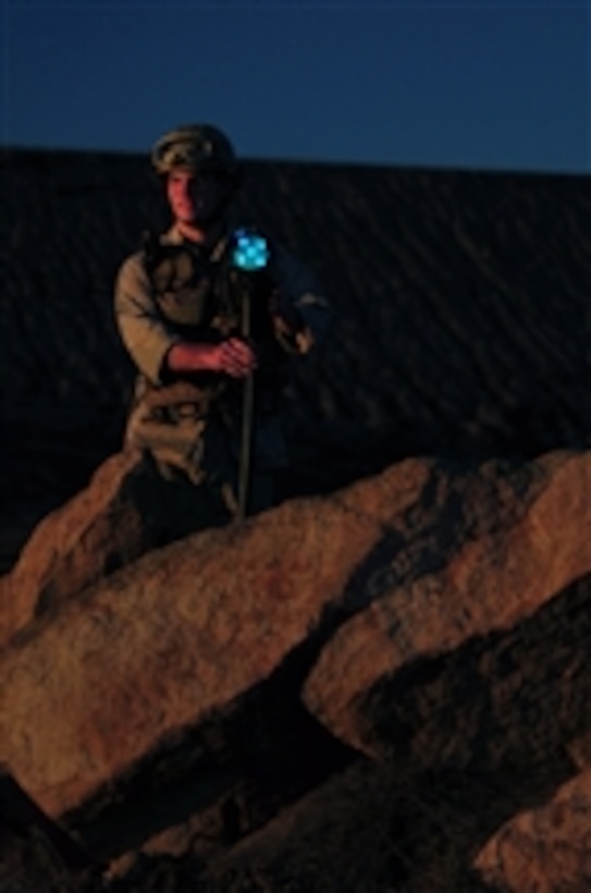 Seaman Matthew Devincenzo, assigned to Beach Master Unit 1 embarked aboard the amphibious assault ship USS Boxer (LHD 4), places a flank night marker to mark the beach lane for landing craft air cushion vehicles on Nov. 15, 2010.  The Boxer is underway off the coast of southern California participating in a composite training unit exercise in preparation for a deployment in early 2011.  