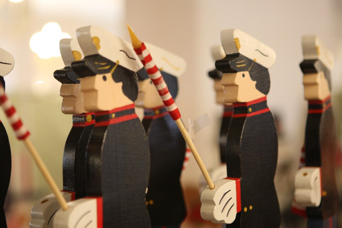 Wooden Marines holding American flags stand in formation waiting for some lucky passer-by to purchase them during the biannual holiday craft fair hosted by the Hidden Talents craft store at the Paradise Point Officers' Club, Nov. 20 and 21. Local artisans come to this event, specializing in various craft projects from jewelry to woodwork to needlework, where locals are able to shop for gift ideas prior to holiday plans.