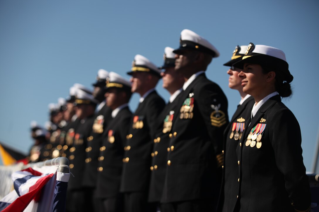 Sailors stand at ease on the aft gangplank of a Navy missile – guided destroyer, the USS Gravely, during her commissioning ceremony at the State Ports in Wilmington, N.C., Nov. 20. The destroyer was named after the late pioneer Vice Adm. Samuel Lee Gravely Jr., who was the first African-American in the U.S. Navy to be commissioned, first to serve aboard a fighting ship as an officer, the first to command a Navy ship, become a fleet commander and a flag officer.