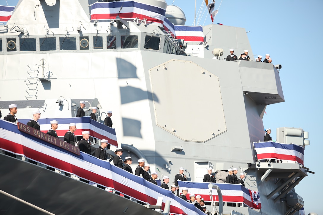 Sailors stand at attention aboard the Navy missile – guided destroyer, USS Gravely, during her commissioning ceremony at the State Ports in Wilmington, N.C., Nov. 20. The ship was named after the late pioneer, Vice Adm. Samuel Lee Gravely Jr., who was the first African-American in the U.S. Navy to be commissioned, first to serve aboard a fighting ship as an officer, the first to command a Navy ship, the first fleet commander and the first to become a flag officer.