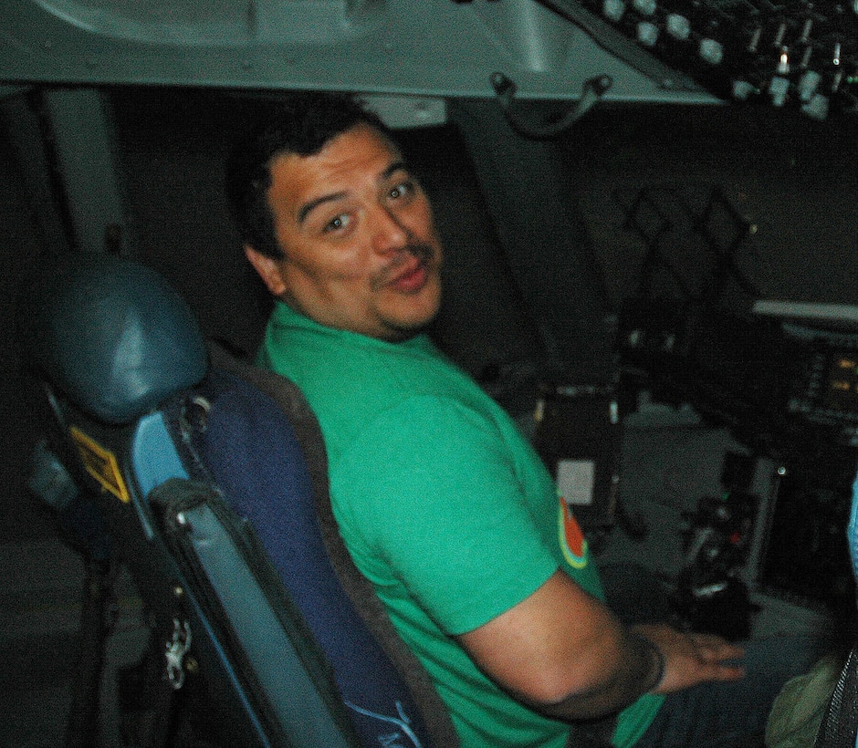 JOINT BASE LEWIS MCCHORD, Wash.- Actor and comedian, Carlos Mencia, of Comedy Central's "Mind of Mencia", sits on the flight deck of a C-17 Globemaster III during his "Tour for the Troops" before his stand-up performance at McChord Field, Nov. 19. Mencia also signed autographs and took photos with military and family members at the JBLM Lewis-Main Post Exchange. (U.S. Air Force photo/Master Sgt. Jake Chappelle) 