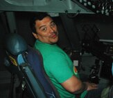 JOINT BASE LEWIS MCCHORD, Wash.- Actor and comedian, Carlos Mencia, of Comedy Central's "Mind of Mencia", sits on the flight deck of a C-17 Globemaster III during his "Tour for the Troops" before his stand-up performance at McChord Field, Nov. 19. Mencia also signed autographs and took photos with military and family members at the JBLM Lewis-Main Post Exchange. (U.S. Air Force photo/Master Sgt. Jake Chappelle) 
