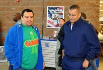 JOINT BASE LEWIS MCCHORD, Wash.- Actor and comedian, Carlos Mencia, of Comedy Central's "Mind of Mencia", has a conversation with Col. Joe Wilburn, commander of Air Force Reserve Command Recruiting Service, before his meet and greet for troops session at the Lewis-Main Post Exchange, Nov. 19. This was just one stop for his "Tour for the Troops" before giving a stand-up performance at McChord Field. Mencia also got to experience being in a C-17 Globemaster III flight simulator here. (U.S. Air Force photo/Master Sgt. Jake Chappelle) 