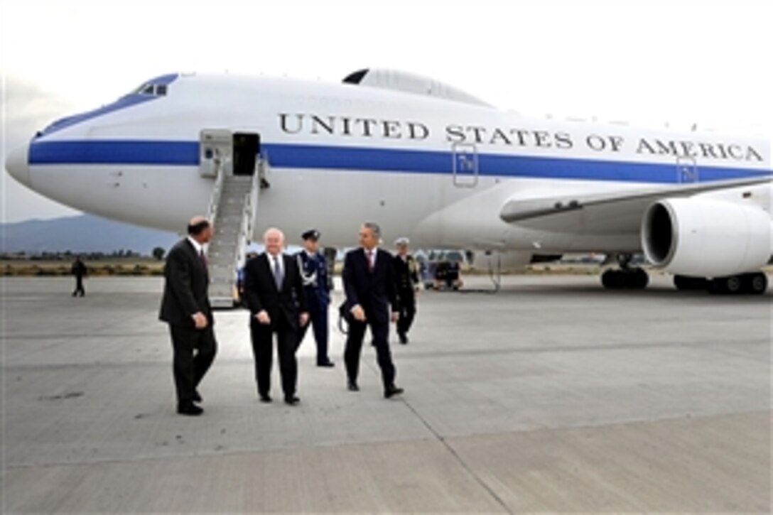U.S. Defense Secretary Robert M. Gates, center, walks with U.S. Ambassador to Chile Alejandro D. Wolff and defense officials upon his arrival in Santiago, Chile, Nov. 19, 2010. 