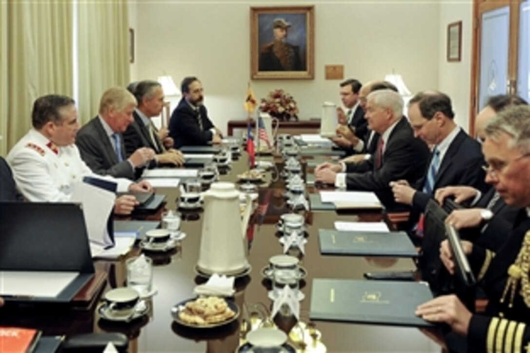 U.S. Defense Secretary Robert M. Gates, center right, and Chilean Defense Minister Jaime Ravinet meet with respective staffs for defense talks at Salon Bernado O'Higgins in Santiago, Chile, Nov. 20, 2010.