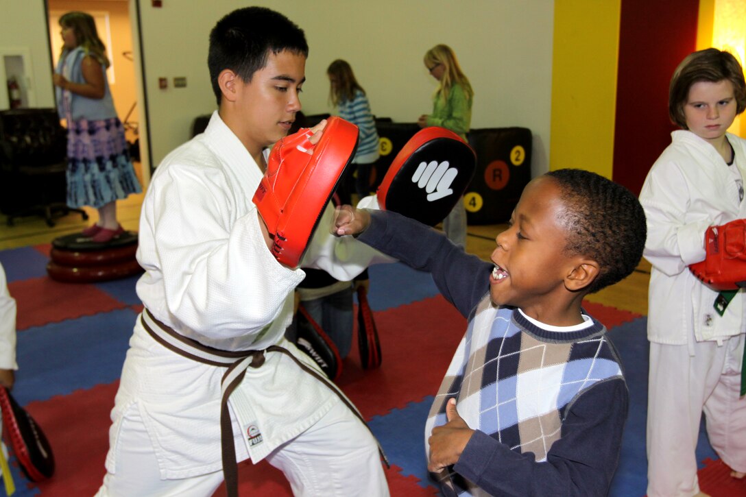Noah A. Johnson, son of a Camp Pendleton sailor, throws punches during a Samurai Expo held for the Camp Pendleton Exceptional Family Member Program at the Abby Reinke Community Center, Nov. 20. The expo featured a book reading by Robert Gould, the founder and creator of “Time Soldiers” adventure books, and a martial-arts demonstration by special guest Sensei Richard Rabago, who has appeared in movies such as “Power Ranger/VR Trooper,” “Full Impact” and “Blood Fist IV.”