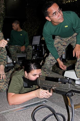 Shannon Legette, a Jane Wayne Day particpant, fires a mock M240G during the Headquarters and Headquarters Squadron Jane Wayne Day here Saturday.