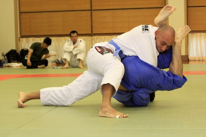 Chief Warrant Officer Sergio Esquivel, bluebelt in Jujitsu and second degree blackbelt in the Marine Corps Martial Arts program, competes against Fujioka Yu, blue-belt competitor, during the 8th Annual West Japan Jujitsu Championship tournament at the Minami Ward Sports Center in Hiroshima Sunday. The Minami Ward Sports Center in Hiroshima hosts many martial arts competitions, which are open to all competitive skill levels and techniques within the rules of the sport.