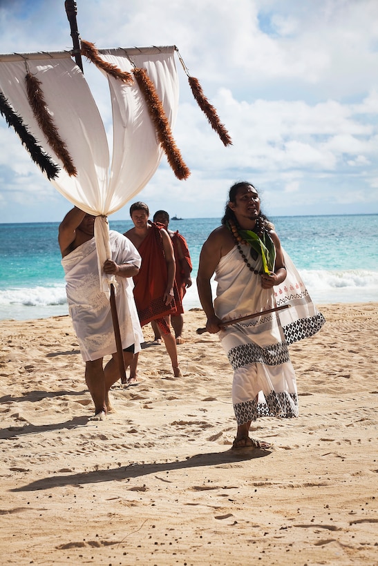 Marked by a wooden cross adorned with white cloth and flowers embodying the deity Lono, members of a ceremonial procession walk off the beach during a Makahiki festival at Bellows Air Force Station in Waimanalo, Hawaii, Nov. 20, 2010. Lasting from October until February, the Makahiki season honors the Hawaiian god Lono, the guardian of peace and health, as he arrives for the transition from Ku, a time of war, politics and construction, to Lono, a time of relaxation and celebration of life.