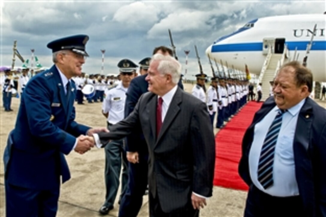 U.S. Air Force Gen. Douglas Fraser, commander of U.S. Southern Command, greets U.S. Defense Secretary Robert M. Gates as he arrives in Santa Cruz, Bolivia, Nov. 21, 2010. Gates and Fraser are in Bolivia to attend a conference of Western Hemisphere defense ministers.
