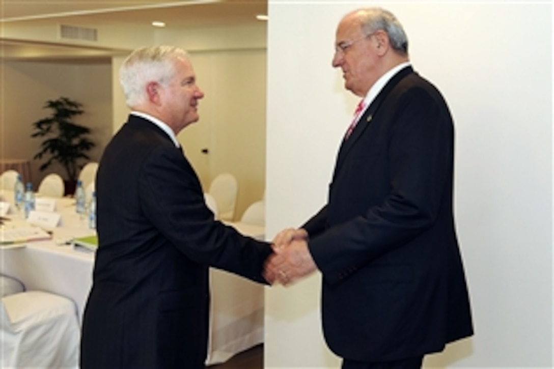 Brazilian Defense Minister Nelson Jobim greets U.S. Defense Secretary Robert M. Gates during a bilateral meeting in Santa Cruz, Bolivia, Nov. 21, 2010. Gates and Jobim are in Bolivia to attend a conference for Western Hemisphere defense ministers.