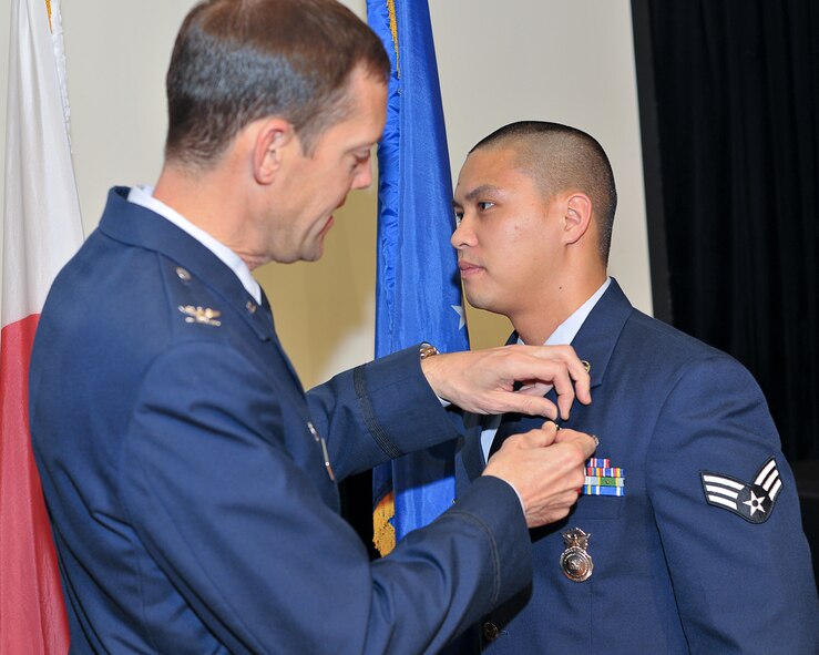YOKOTA AIR BASE, Japan -- Senior Airman Roy Tort, 374th Security Forces Squadron, receives the Air Force combat action medal here Nov. 23. (U.S. Air Force photo/Osakabe Yasuo)