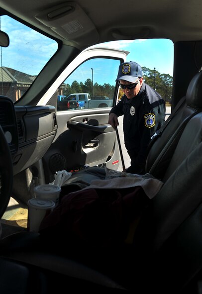 MOODY AIR FORCE BASE, Ga. -- Steven Lheureux, Department of the Air Force security guard performs a routine car inspection during a normal duty day Nov.22. On a weekly average the DAF guards can expect to search 60 to 120 vehicles.  (U.S. Air Force photo/Airman 1st Class Joshua Green)(RELEASED)
