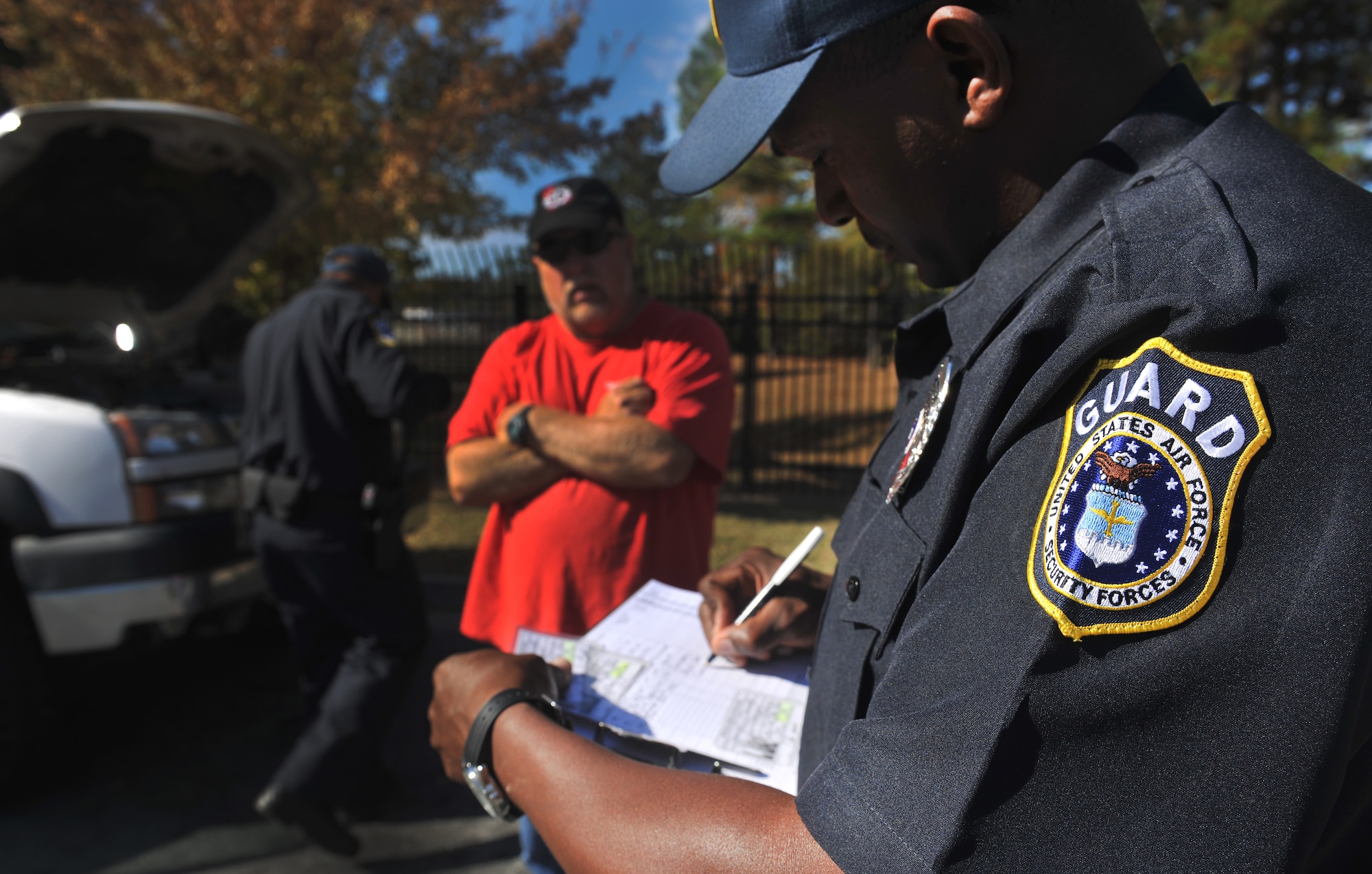MOODY AIR FORCE BASE, Ga.--Department of the Air Force security guards perform a routine car inspection during a normal duty day Nov.22. To help with a change that was happening Air Force-wide, members of the 23rd Security Forces helped manned the gate while the civilian positions on Moody switched from contractors to Department of the Air Force security guards. (U.S. Air Force photo/Airman 1st Class Joshua Green)(RELEASED)

