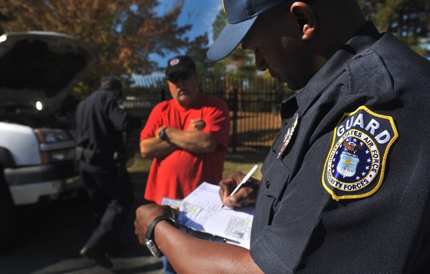 MOODY AIR FORCE BASE, Ga.--Department of the Air Force security guards perform a routine car inspection during a normal duty day Nov.22. To help with a change that was happening Air Force-wide, members of the 23rd Security Forces helped manned the gate while the civilian positions on Moody switched from contractors to Department of the Air Force security guards. (U.S. Air Force photo/Airman 1st Class Joshua Green)(RELEASED)
