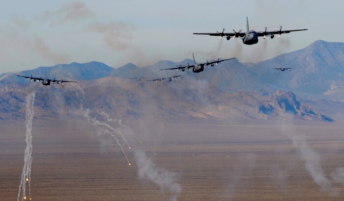 NELLIS AIR FORCE BASE, Nev.-- A formation of  U.S. Air Force C-130 Hercules aircraft fire off chaff and flare countermeasures over the Nevada Test and Training Range Nov. 17 during a Mobility Air Forces Exercise. More than 40 C-17 Globemaster III and C-130 Hercules cargo aircraft assembled in aerial formations over the NTTR to conduct air and ground operations as part of the bi-annual U.S. Air Force Weapons School MAFEX. (U.S. Air Force photo/ Master Sgt. Kevin J. Gruenwald)