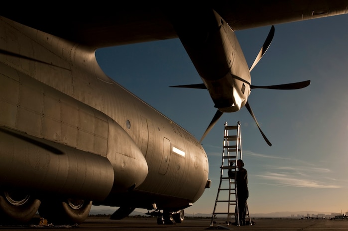 NELLIS AIR FORCE BASE, Nev. --  Tech. Sgt. Nathan McAdams, flying crew chief with the 86th Aircraft Maintenance Squadron, Ramstein Air Force Base, Germany positions a ladder to conduct post flight checks of a C-130 Hercules engine intakes  after landing at Nellis during the Mobility Air Forces Exercise held over the Nevada Test and Training Range,  Nov 17. Approximately 40 C-17 Globemaster III and C-130 Hercules cargo aircraft will assemble in aerial formations over the NTTR to conduct air and ground operations as part of the bi-annual, U.S. Air Force Weapons School Mobility Air Forces Exercise.  (U.S. Air Force photo by Tech. Sgt. Michael R. Holzworth)(Released)