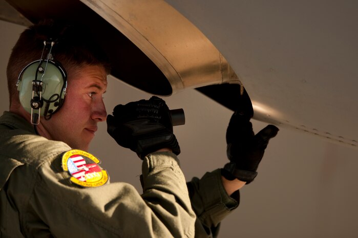NELLIS AIR FORCE BASE, Nev. --  Tech. Sgt. Nathan McAdams, a flying crew chief with the 86th Aircraft Maintenance Squadron, Ramstein Air Base, Germany, conducts post-flight checks of a C-130 Hercules after landing at Nellis during a Mobility Air Forces Exercise Nov 17. More than 40 C-17 Globemaster III and C-130 Hercules cargo aircraft assembled in aerial formations over the Nevada Test and Training Range to conduct air and ground operations as part of the bi-annual U.S. Air Force Weapons School MAFEX. (U.S. Air Force photo by Tech. Sgt. Michael R. Holzworth)