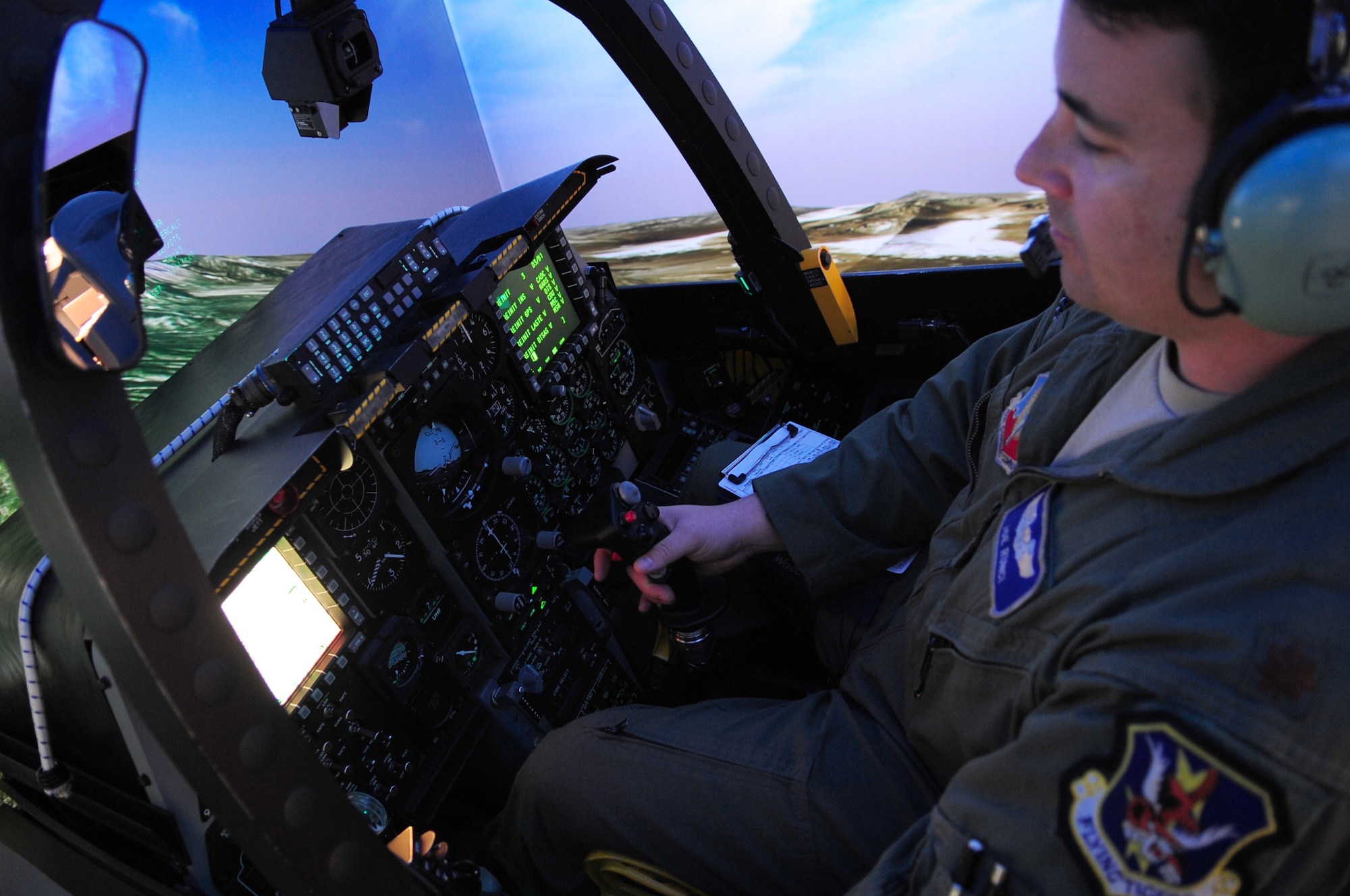 MOODY AIR FORCE BASE, Ga.-- Maj. Joseph Runci, 74th Fighter Squadron A-10C Thunderbolt II pilot, checks his altitude inside the Full Mission Trainer, an A-10 cockpit simulator, as he prepares for the Green Flag West 11-02 exercise Nov. 22. The Green Flag West exercise is designed for close-air support units to practice with U.S. Army forces before being deployed down range together. (U.S. Air Force photo/Senior Airman Stephanie
Longoria)(RELEASED)
